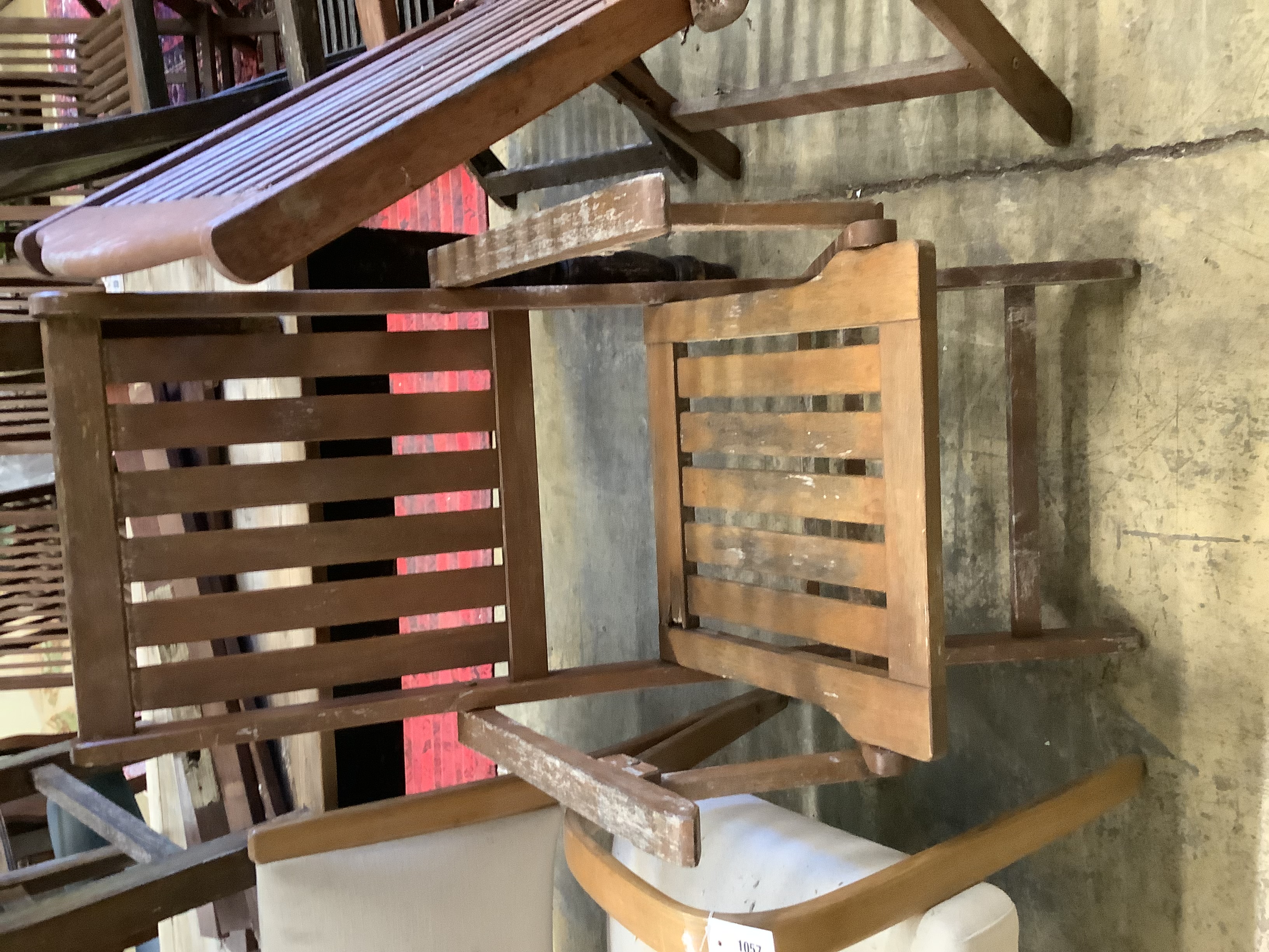 Three various teak folding garden elbow chairs together with two other teak garden chairs